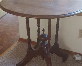 Side table with ball and claw feet on casters
