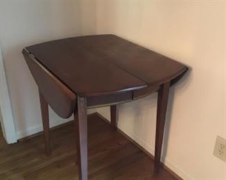 Drop leaf table with handpainted flowers on each end.