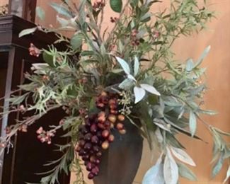 Pair of urns with greenery and berries.