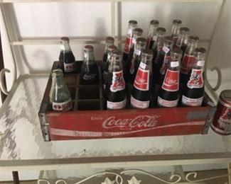 Old Coca-Cola crate and commemorative University of Alabama football cokes.