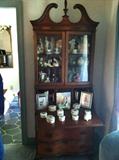 beautiful china cabinet full of nice porcelain collectibles and figures
