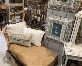 Vintage feed sack spring base chaise, vintage cotton covered pillows, antique Victorian gesso and wood frames with nautical bird lithos, old milk crates, antique oil lamps, old drawers, antique fern stand 