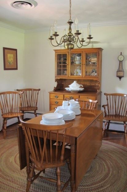 Maple drop leaf dining room table with six chairs, excellent condition.  Oval braided rug.