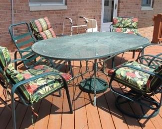 Green, strap, outdoor furniture includes:  one table and umbrella; 4 chairs for table and two rotating chairs. two chairs no cushions