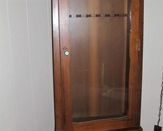 Tall gun cabinet that hold 6 guns; also has second locked area at bottom of cabinet.