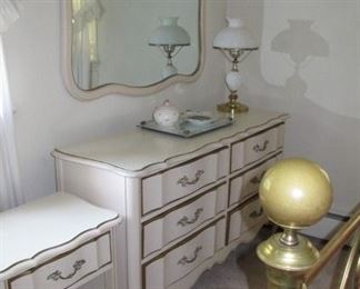 French Provincial double dresser with mirror and nightstand; milk glass lamp.