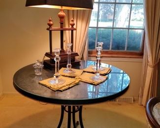 black table with metal base, glass top 