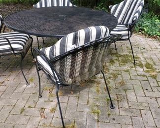 Vintage wrought iron, patio table,  w/ 4 chairs and cushions
 Woodard ?  Pretty sure. 
