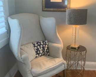 The chair, side table and lamp are sold. The art on the wall is still available for purchase.