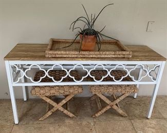 The wicker tray and stools are sold. The console table is still available for purchase.