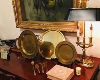 executive desk filled with antique brass desk sets.  Notice the large painting