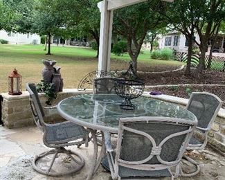 $225- OBO- Glass top and metal base patio table and four swivel rocking chairs 