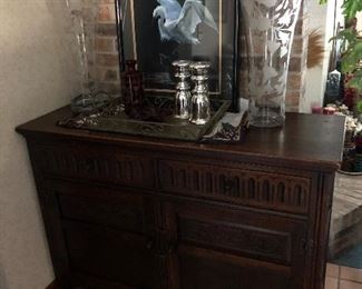 Antique sideboard
Signed numbered art
Red Cut to Clear Decanter 
Pr Michele Dern signed ‘Morning Glory’ Vases
Mercury Glass candle holders