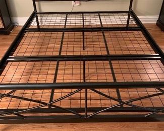 Black metal queen size platform bed.