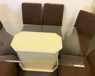 glass dining room table and covered fabric chairs