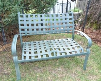 Green metal loveseat with green strap supports. $70 comes with cushions.