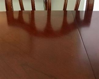 Mahogany dining room table. Sits eight (8) comfortably. Comes with eight (8) dining room table chairs. Good condition, minor wear.