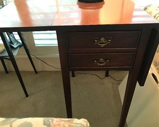 A Vintage 1990's Mahogany Pembroke Table. Dovetailed drawer construction. Good Condition. Each flap is 8.75 inches. Fun fact: A Pembroke table is a drop-leaf table designed for light use. The name Pembroke came from Henry Herbert, 9th Earl of Pembroke (1693-1751) He was a noted connoisseur and amateur architect.