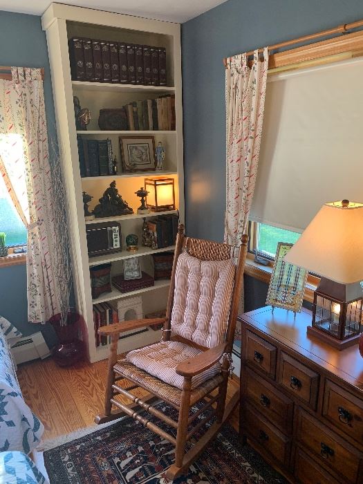 Guest bedroom 
Rocking chair, Frank Lloyd Wright stained glass, modern chest of drawers, vintage books, ornate brass bookends, cast iron man of war/knight 