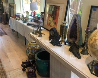 small to large wooden stands with more pottery