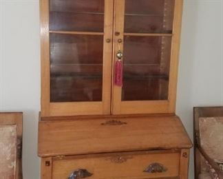 Antique oak secretary with glass front doors.