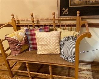 Great wicker seated spindle bench.  Lots of toss pillows to choose from