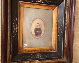 Antique photograph in ornate frame.