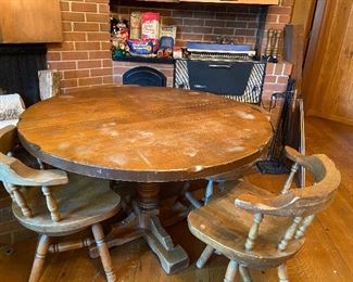 Solid wood table with 2 leaves and 4 chairs.