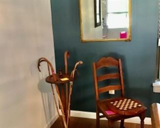 Canes on smoking stand, antique chair, gilded mirror 