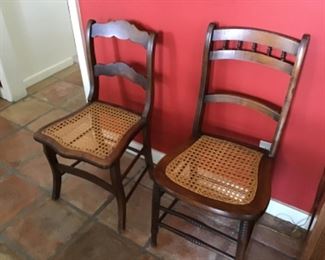 Two of several cane bottom chairs with custom cushions 