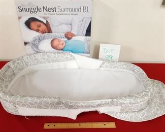 D-T-89   $22  Snuggle Nest Surround BL Portable Infant Sleeper