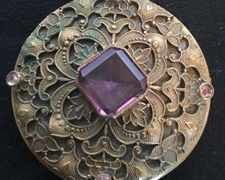 Pretty antique brass round compact with amethyst colored stone and floral decoration