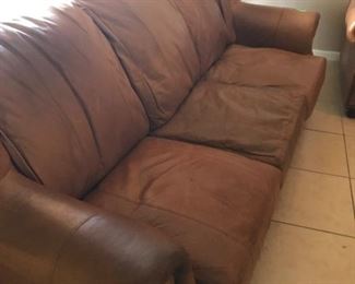 Real leather couch set with extra cushion covers.
