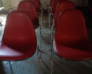 8 upholstered shell chairs by Eames, stamped with Herman Miller