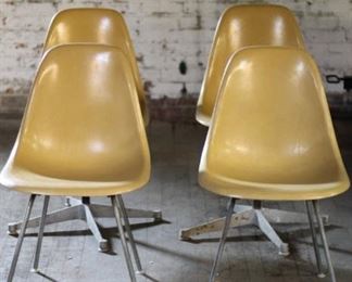 4 Eames shell chairs in ochre. 2 with H-bases, 2 with swivel bases.
