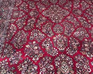 With brilliant shades of red, laced with green foliage and black highlights, this 9’ x 12’ Area Rug is in wonderful condition.