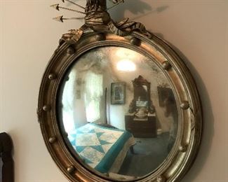 Federal Period Eagle Mirror is aged making the reflection feel mysterious. 