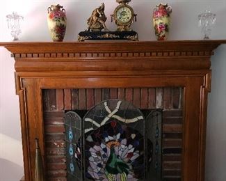 The Fireplace is home to a Tiffany Style Fireplace Screen with a Peacock motif.  On the mantle buyer’s will find an Ansonia Clock front and center. The clock is flanked by a matched pair of Nippon Vases and offset by Heise Candle Holders.  