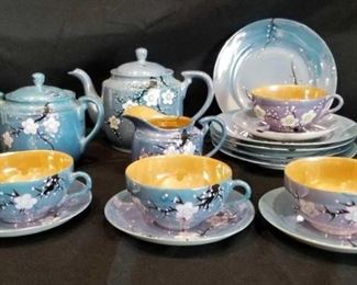 Blue Lusterware with Apple Blossom Design Tea Set	
Made in Japan, Blue with Orange Lusterware 5 Dessert Plates, 4 Cups, 4 Saucers, Tea Pot with Lid, Cream and Sugar with Lid, Crack on Sugar Bowl See Pictures