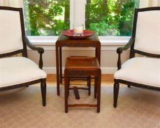 Carved Rosewood Nesting Tables  $175
Set of four. As is (stretcher bar on one table needs to be reglued)       Two White Armchairs With Dark Wood $395 each