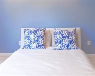 King platform bed. Neutral nubby loose-weave fabric upholstery