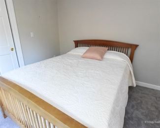 Queen Bed, arched headboard, and footboards with spindles. The footboard has significant fading from the sun. It is sturdy, and a perfect candidate for a painting project.  $150