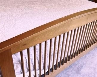 Queen Bed, arched headboard, and footboards with spindles. The footboard has significant fading from the sun. It is sturdy, and a perfect candidate for a painting project.  $150