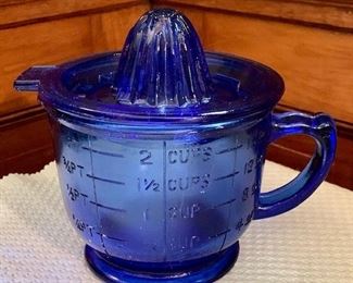 Item 398:  Blue measuring cup with citrus juicer:  $22.00