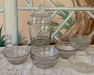 Item 98:  Vintage EAPG Glass Canister with frosted base and frosted Lion Finial, two vintage glass candlesticks and eight pressed glass dessert dishes: $65                                                                                                                                    EAPG Canister - 9"