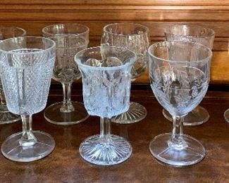 Item 215:  Eleven pressed glass assorted glasses:  $25