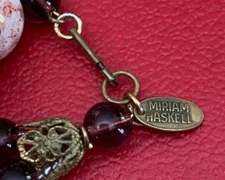 Showing the little Miriam Haskell flat oval  stamped plaque from the 1950-1970's.