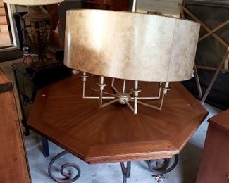 Octagonal wood table with iron base, large mica shade chandelier