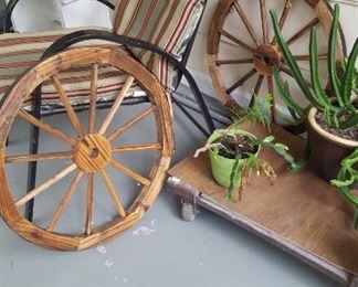 Porch chair, wagon wheels, & plants 