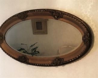 Over 100 year old mirror, sold wood backing.  Some wear, but very beautiful.